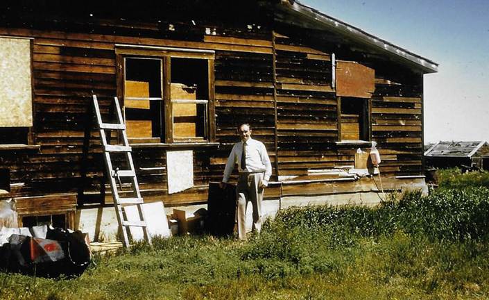 A person standing outside a house

Description automatically generated with low confidence