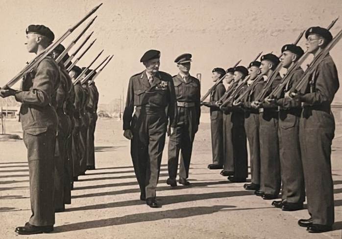A picture containing text, person, outdoor, military uniform

Description automatically generated