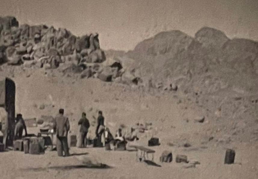 A group of people standing in a desert

Description automatically generated with medium confidence