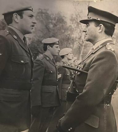 A picture containing person, military uniform, brass, standing

Description automatically generated