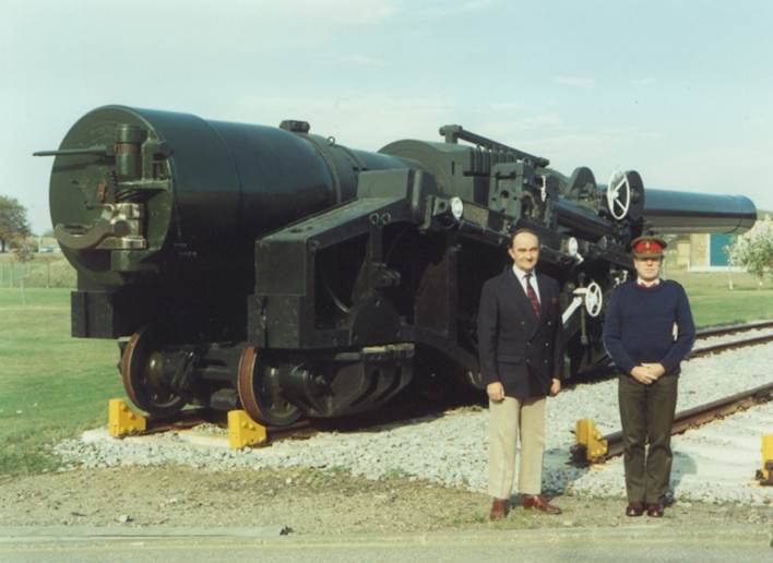 A couple of men standing next to a train

Description automatically generated with low confidence