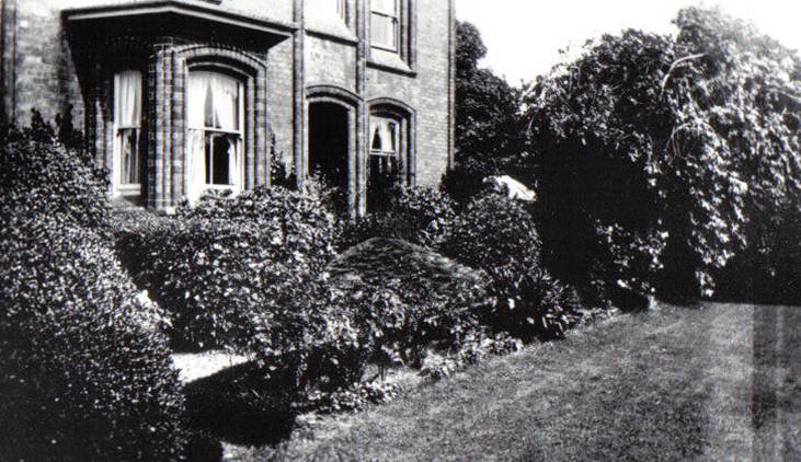 A black and white photo of a house and some trees

Description automatically generated with low confidence