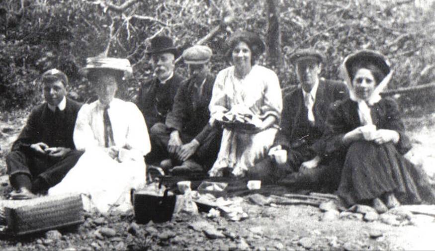 A vintage photo of a group of people posing for the camera

Description automatically generated