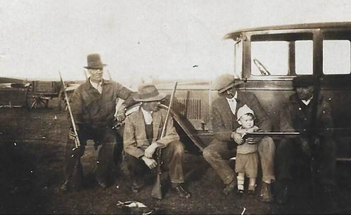 A picture containing old, black, group, posing

Description automatically generated