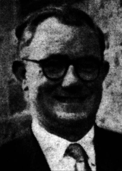 A person wearing glasses and a suit

Description automatically generated