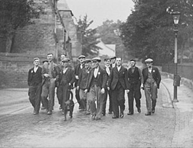 A group of men walking on a road

Description automatically generated