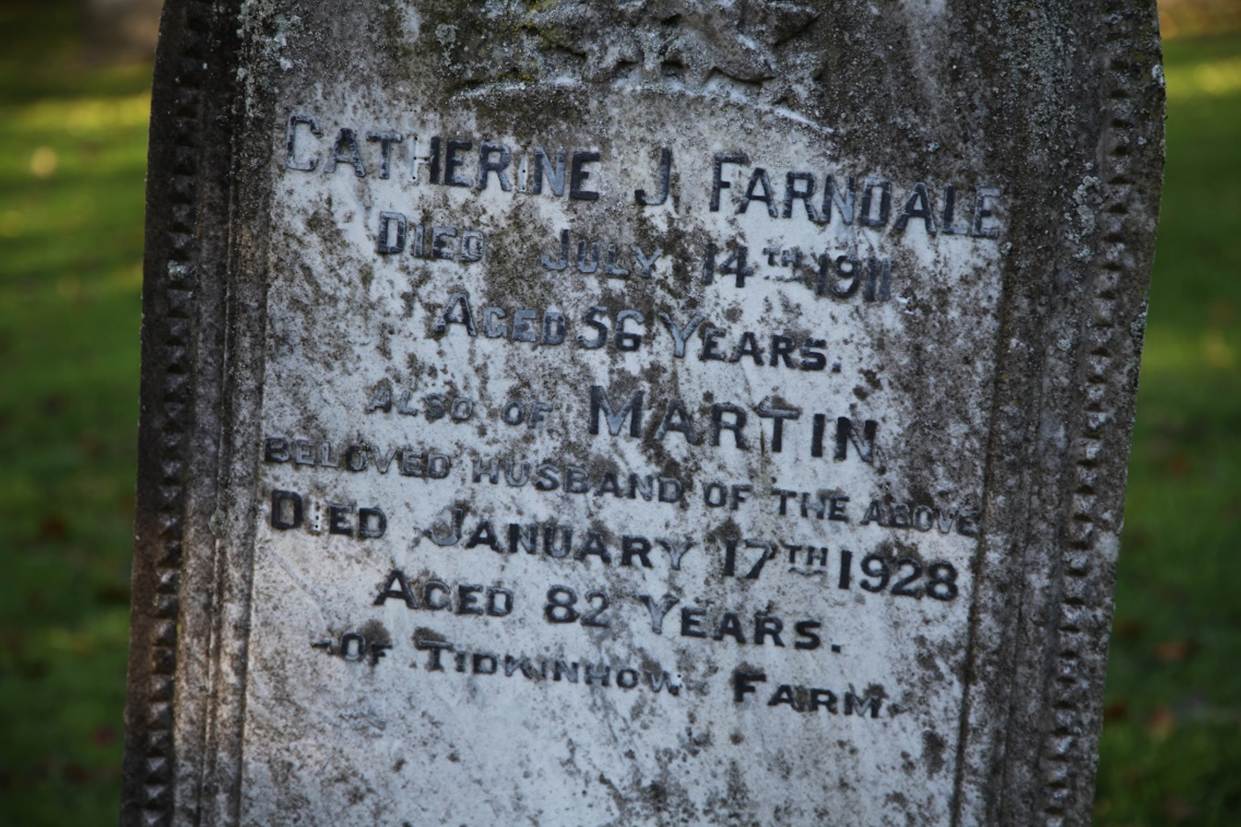 Close-up of a tombstone with text
Description automatically generated