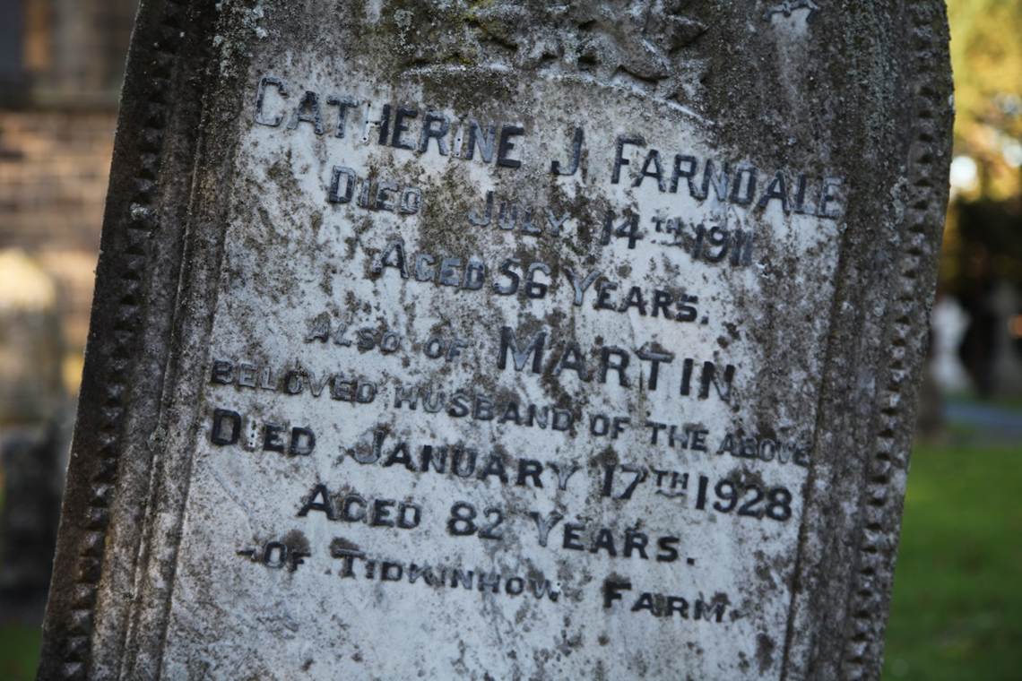Close-up of a tombstone with a stone
Description automatically generated