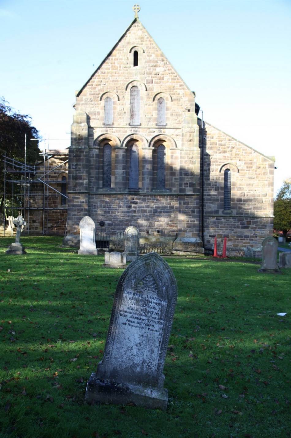 A stone monument in front of a building
Description automatically generated