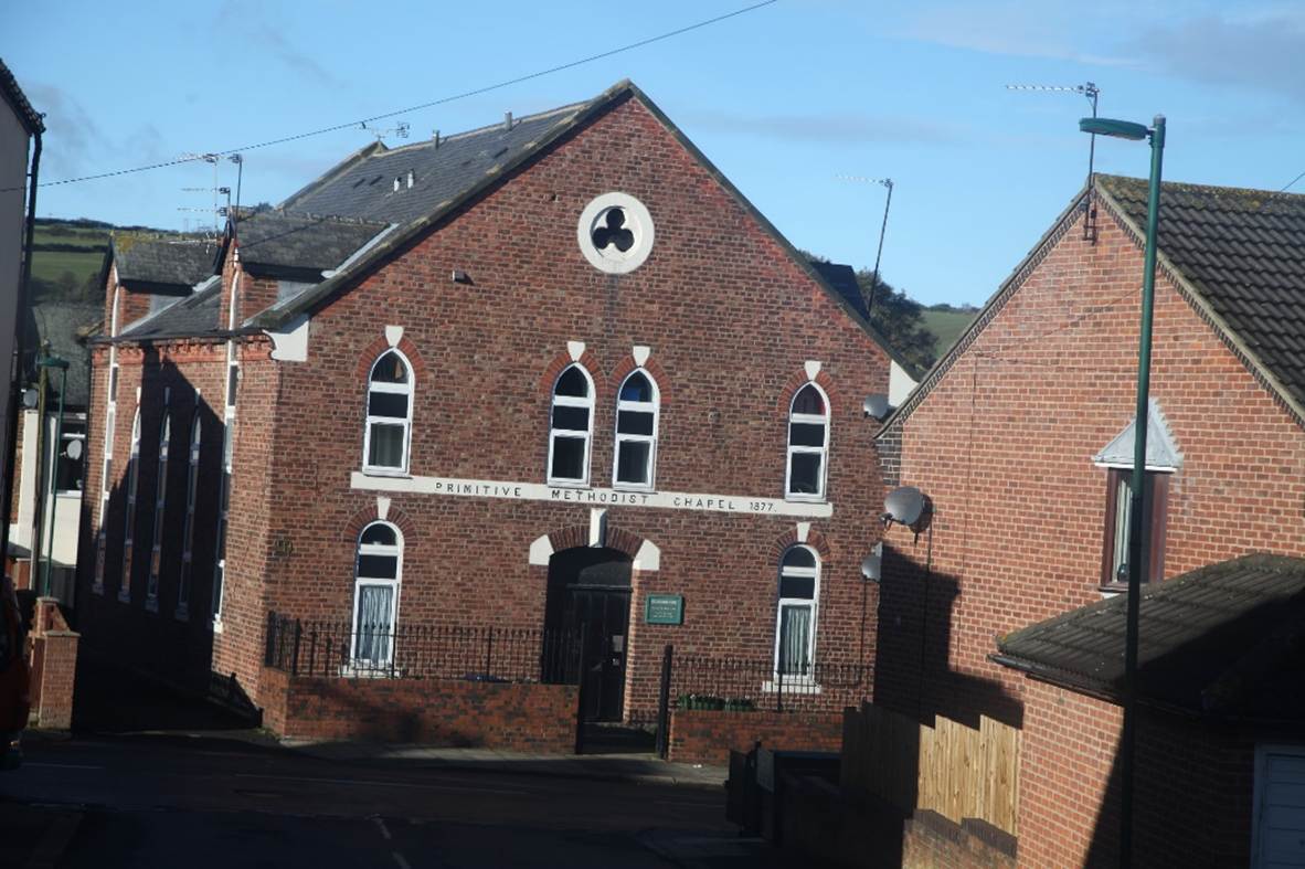 A brick building with a gate
Description automatically generated