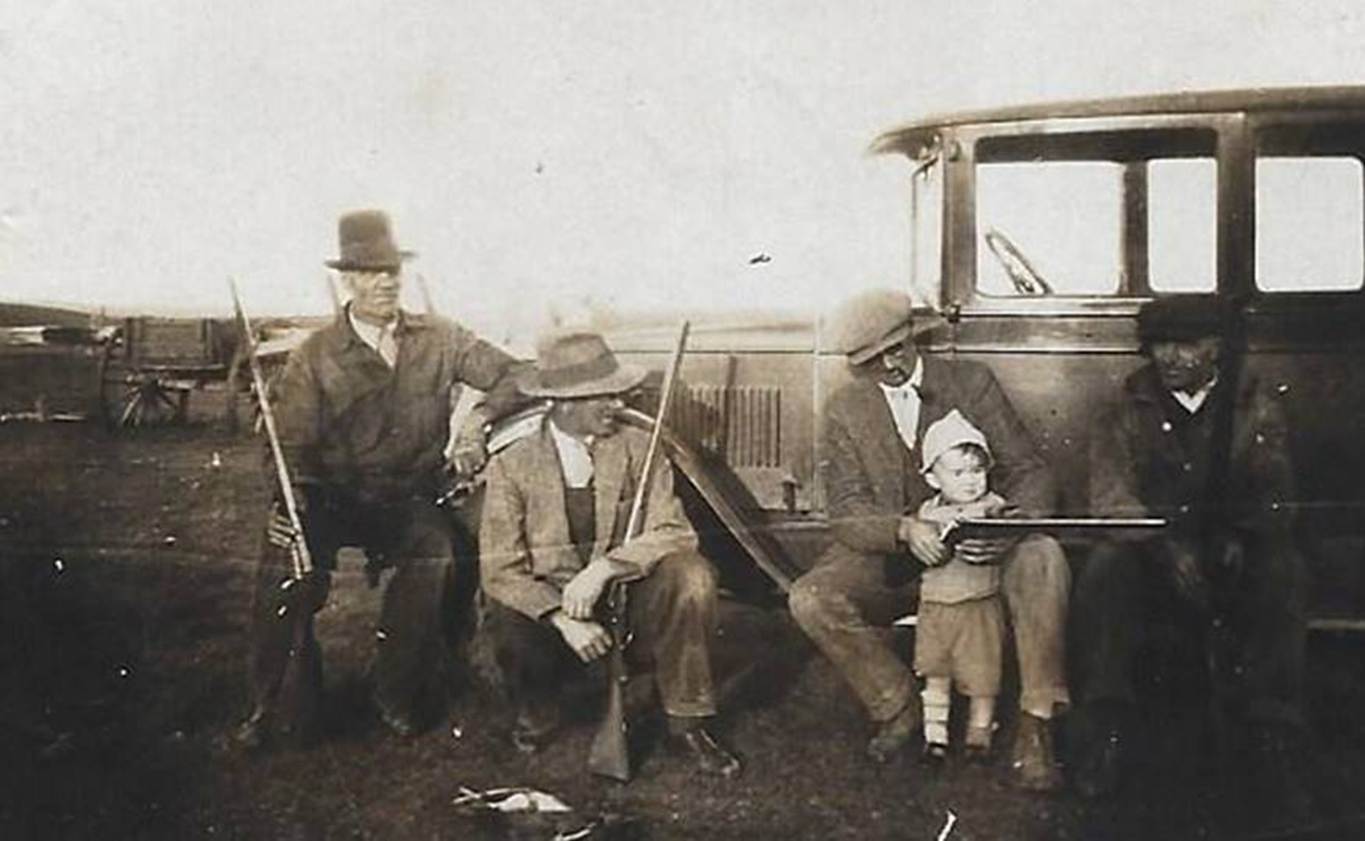 A picture containing old, black, group, posing
Description automatically generated