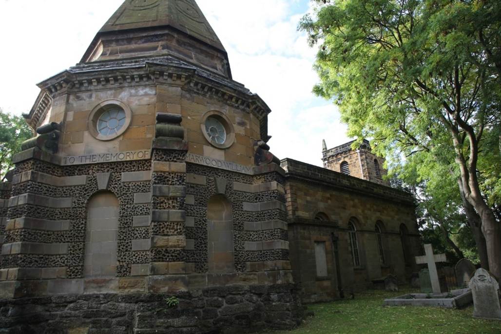 A stone building with a steeple
Description automatically generated