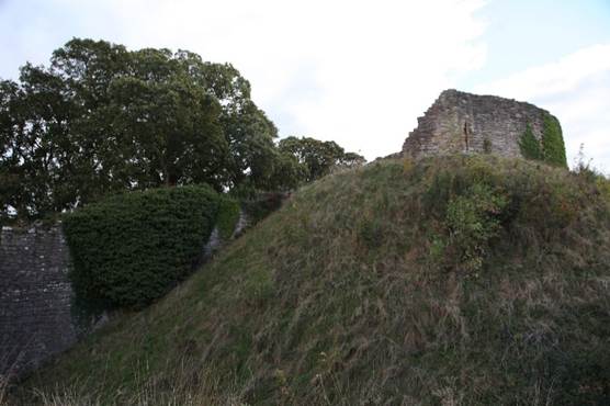 A stone building on a hill
Description automatically generated