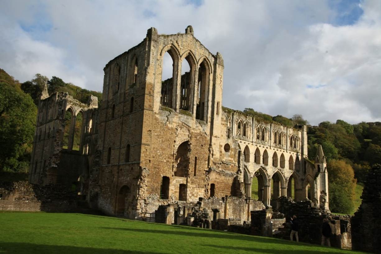 A stone building with arches
Description automatically generated