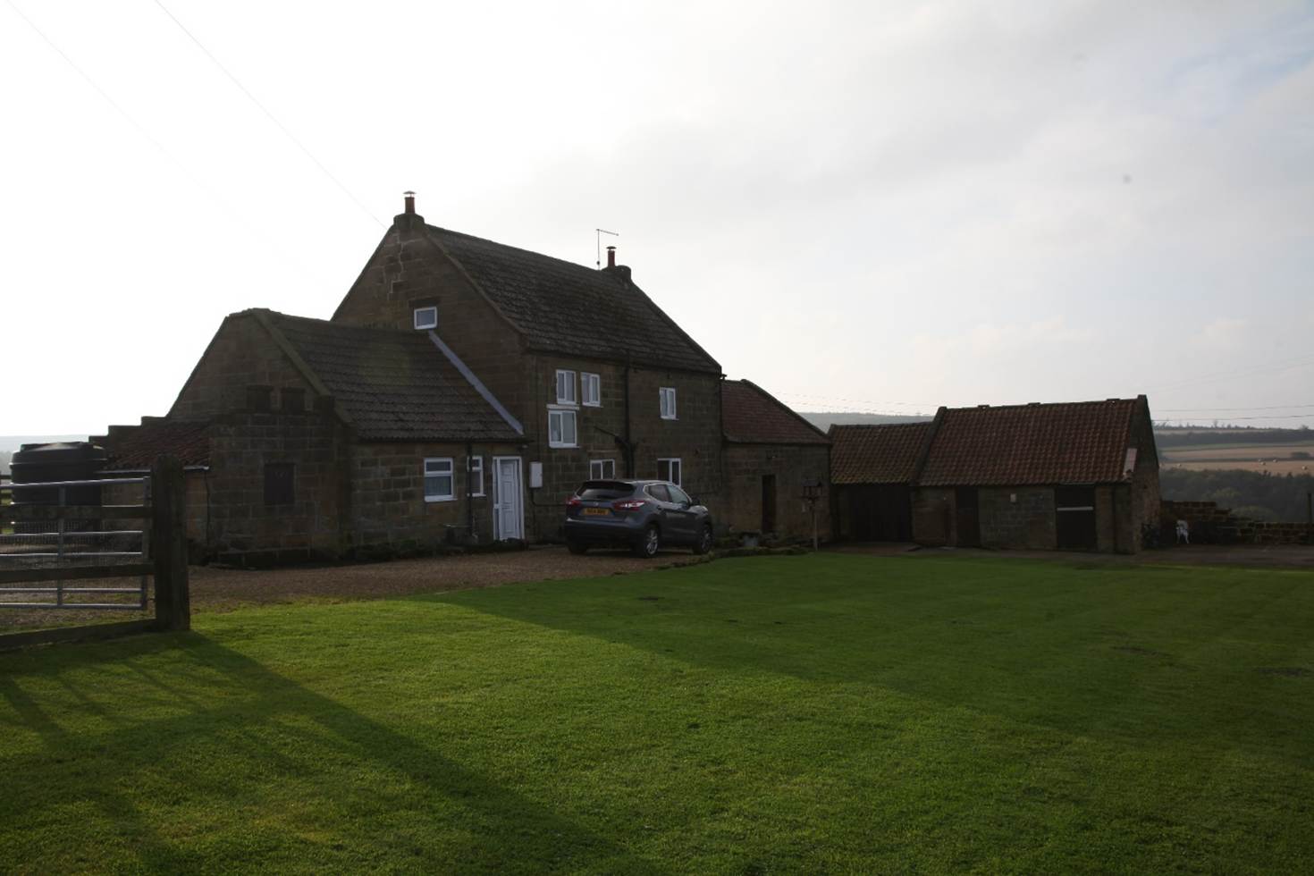 A house with a car parked in front of it
Description automatically generated