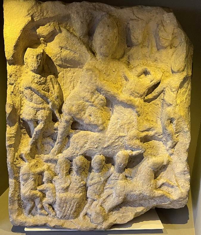 A stone with a human face carved into it
Description automatically generated with medium confidence