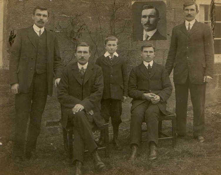 A group of men in suits Description
            automatically generated