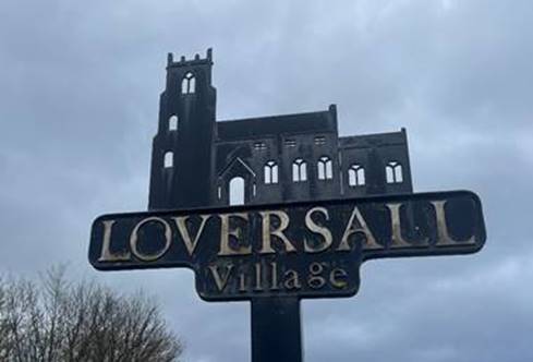 A sign with a castle in the background
Description automatically generated